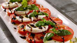 © M - Fresh Caprese Salad with Tomato, Mozzarella, Basil, and Balsamic Glaze on White Plate