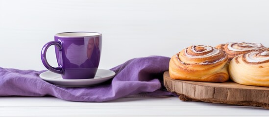 Aufkleber - Coffee cup on a wooden stand beside sweet rolls on a purple napkin. Displayed on a white background with copy space image available.