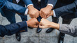 © pattozher - group of businessman fist bumping, business unity concept