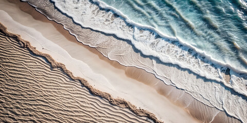 Wall Mural - a top view of a beautiful image of a sandy beach with a wave rolling in. The wave is white and foamy