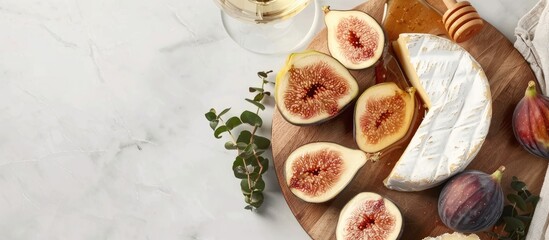 Aufkleber - Top view of Camembert or brie cheese paired with fresh figs, honeycomb, and a glass of wine on a serving board against a white background with room for text or other images. with copy space image