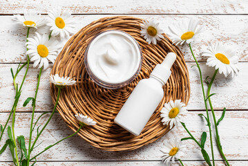 Canvas Print - Natural organic face cream and serum with chamomile flowers