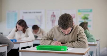 Poster - High school, boy and students at desk for learning, thinking and education for exam project. Reading, writing and young people studying for test in classroom with knowledge, information and advice