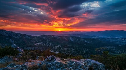 Sticker - Watching the sunset from a mountain peak, the sky ablaze with color and the landscape bathed in a warm glow, is a breathtaking experience.