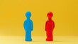 © Yulia - Two Colorful HumanShaped Figures on Yellow Background  Blue vs Red Concept Imagery