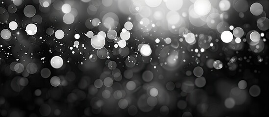 Wall Mural - Blurry black and white bokeh providing an abstract background with a festive touch perfect for Christmas and New Year's, with copy space image available.