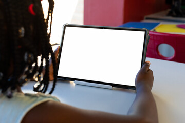 Sticker - Using tablet for online learning, child studying in school classroom, copy space