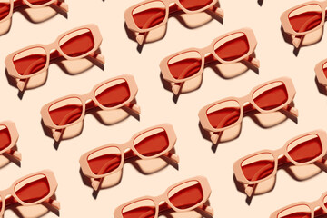 Sticker - Minimal pattern of Stylish sunglasses with pink Frame on peach beige color background, sunlight shadow, summer fashion plastic-framed glasses. Aesthetic top view eyewear, geometric patterns