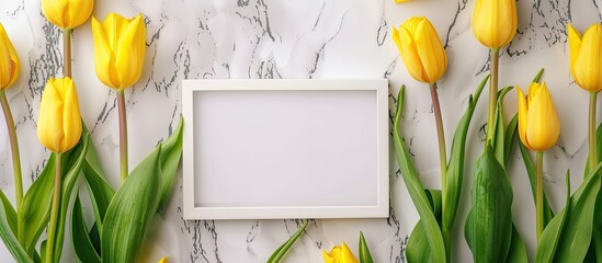 Poster - Copy space image featuring yellow tulips displayed with a white marble background and a blank picture frame.