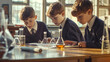 © chekart - Three students in school uniforms at a chemistry lesson. They are sitting at a table in the school laboratory. They are looking at a book and seem to be studying something