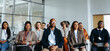 © Jacob Lund - Diverse group of professionals attending a work conference in a modern office setting
