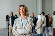 © Jacob Lund - Happy female CEO at a business conference with diverse colleagues in the background