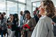 © Jacob Lund - Business professionals interacting and laughing during a lively corporate event