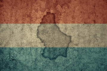 Wall Mural - map and flag of luxembourg on a old vintage crack paper background .