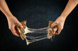 © Grafvision - Two hands pulling apart a grilled cheese