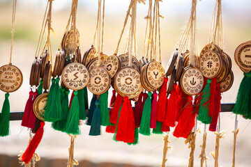 Kazakh national souvenirs, pendants with zhuz and clan names. Ethnic jewelry, handicrafts made of wood, reflecting the rich culture and traditions of Kazakhstan. Turkestan, Kazakhstan - June 30, 2024