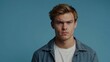 © Tanja - Young man with serious expression in denim jacket