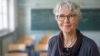 © cobaltstock - Mature teacher in classroom with copy space