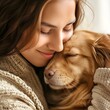© waqas - A touching moment of a young woman lovingly embracing her golden retriever, emphasizing the deep bond and affection between a person and their pet.