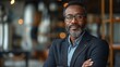 © armensl - businessman corporate portrait in office, mature black middle aged manager business man. Portrait of happy african man wearing spectacles and looking at camera.
