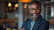 © armensl - businessman corporate portrait in office, mature black middle aged manager business man. Portrait of happy african man wearing spectacles and looking at camera.