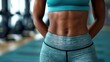 © Tetiana - A close-up shot of a womans toned abdomen, showcasing the results of dedicated fitness
