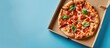 © meristock - Blue background with pizza box showcasing design and logo for pizza delivery service, featuring ample copy space image.