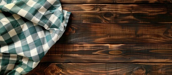 Wall Mural - an aerial view of a wooden table topped with a checkered tablecloth serves as a kitchen background, 