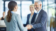 © XaMaps - A joyful elderly couple and financial advisor celebrate positive retirement fund review.