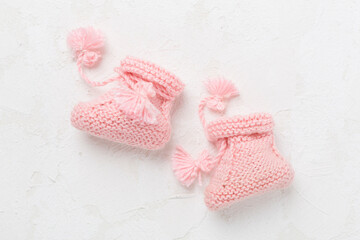 Wall Mural - Pink baby booties on white background, top view