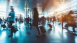 © tashechka - A bustling airport terminal with passengers moving, captured with motion blur, highlighting the fast-paced travel environment.