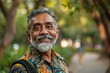 © CogniLens - Portrait of a merry indian man in his 50s sporting a technical climbing shirt in front of vibrant city park