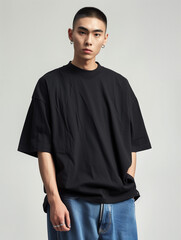 Wall Mural - asian male model wearing a black heavyweight cotton blank oversize t shirt, baggy blue jeans, clothing mockup