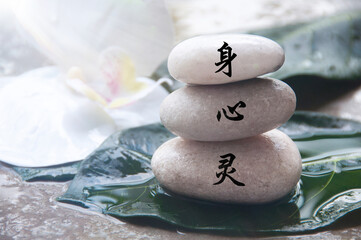 Body, mind and spirit in Chinese character on zen stones. Zen concept