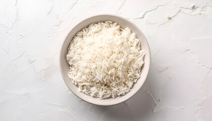 Wall Mural - Bowl of delicious rice on white table, top view