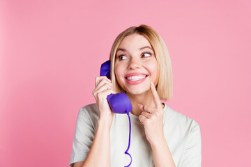 Wall Mural - Photo of toothy beaming nice woman dressed t-shirt talk on retro phone look at discount empty space isolated on pink color background