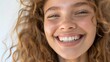 © Ева Поликарпова - A happy woman with long curly hair smiling at the camera