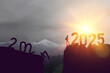© Shi  - New year 2025 or straight forward concept. Text 2024 to 2025 written on the mountain top with at sunrise. Concept of planning, goal, challenge, new year resolution and start. High quality photo