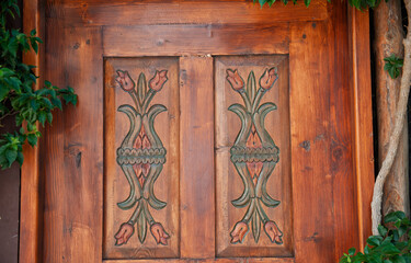 Old red wooden texture of vintage door with flower ornament