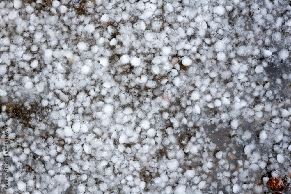 Hailstones cover the ground after a heavy thunderstorm in spring in ...