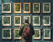 © anurakss - traveler looking at pictures of medicinal herbs plants on the wall in exhibit room