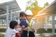 © chaunpis - Working engineer mom takes her kid to wind turbine farm. Green energy and sustainable future concept.