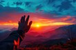 © Pungu x - Silhouette of a hand reaching towards a vibrant sunrise in the mountains, dramatic and inspiring, hand reaching sunrise, hope and achievement