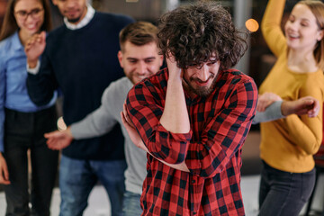 Wall Mural - A group of young business people have fun playing interesting games while taking a break from work in a modern office. Selective focus 