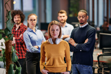 Portrait of successful creative business team looking at camera and smiling. Diverse business people standing together at startup. Selective focus 