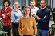 © .shock - Portrait of successful creative business team looking at camera and smiling. Diverse business people standing together at startup. Selective focus