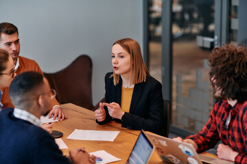 in the vibrant ambiance of a modern startup office, a diverse team of business professionals engage 