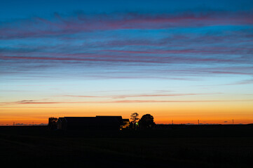 Wall Mural - beautiful evening red over a farmhouse in the dutch countryside
