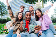 © Jose Calsina - Group of young teenage students looking at their notes on the internet using a cellphone and celebrating joyfully having passed. Successful friends excited cheering with a smartphone. Classmates goals