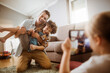 © Vorda Berge - Father playing with son while being photographed by daughter at home